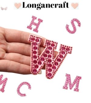A hand holding a Pink Iron On Letters