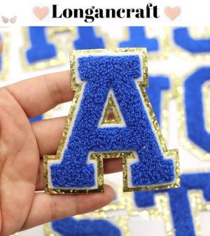 A person is holding a Dazzling Blue Chenille Iron On Letters