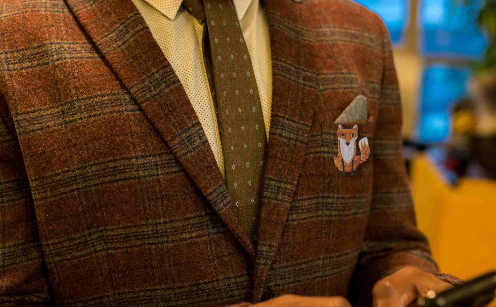 A man donning a tweed blazer showcasing iron on patch ideas.