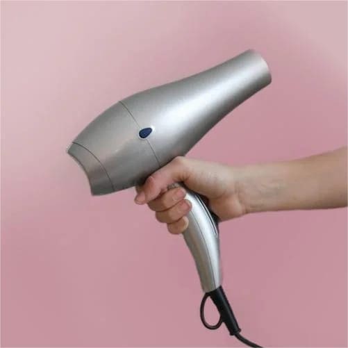 To remove an iron-on patch using a Hair Dryer